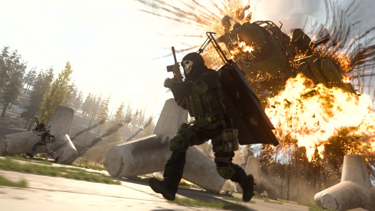 A Warzone operator runs past an exploding vehicle in Verdansk