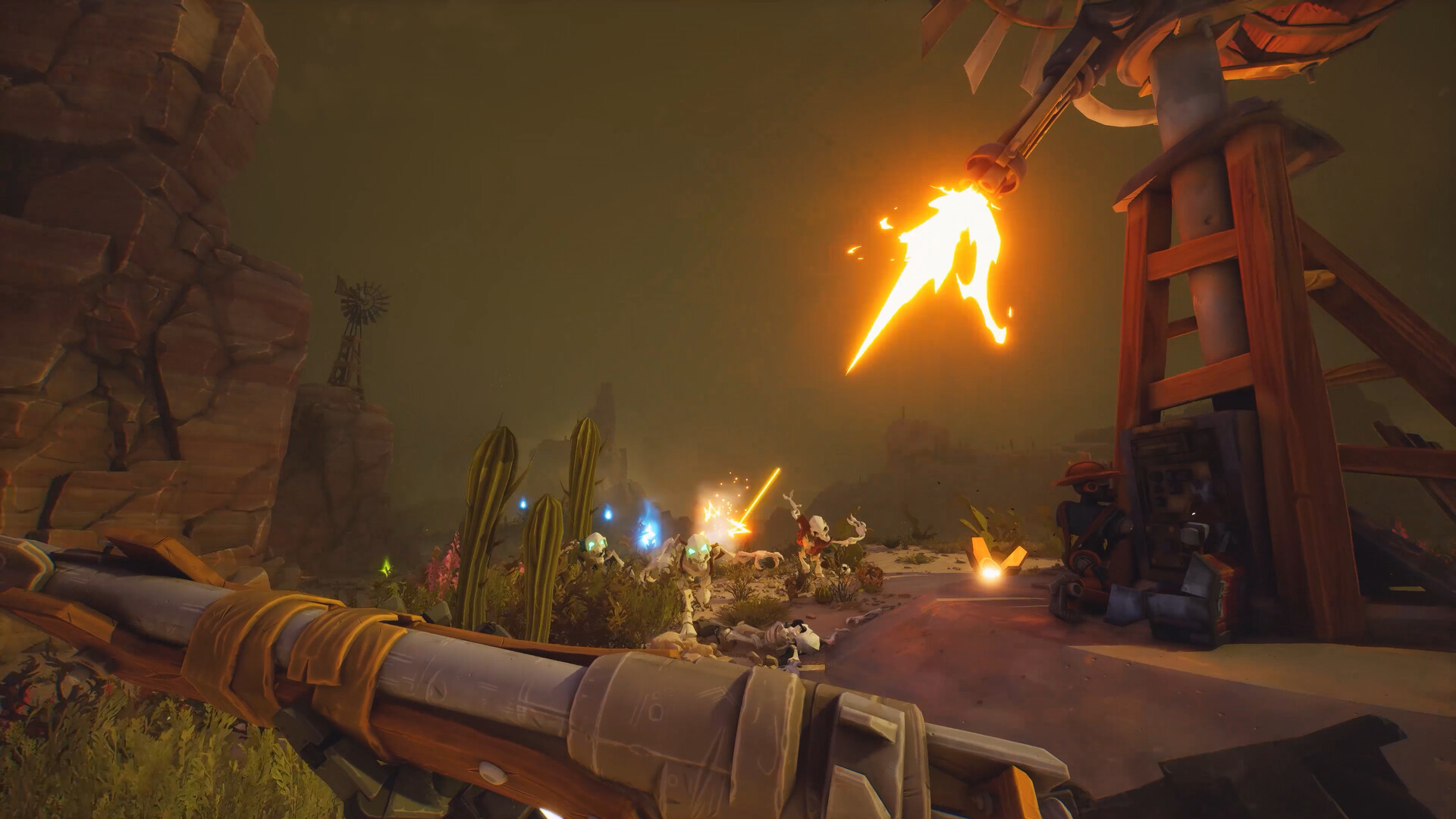 Desert battle scene with a large fiery spear swung from a crane toward glowing enemies, rocky cliffs and cacti in the foreground.