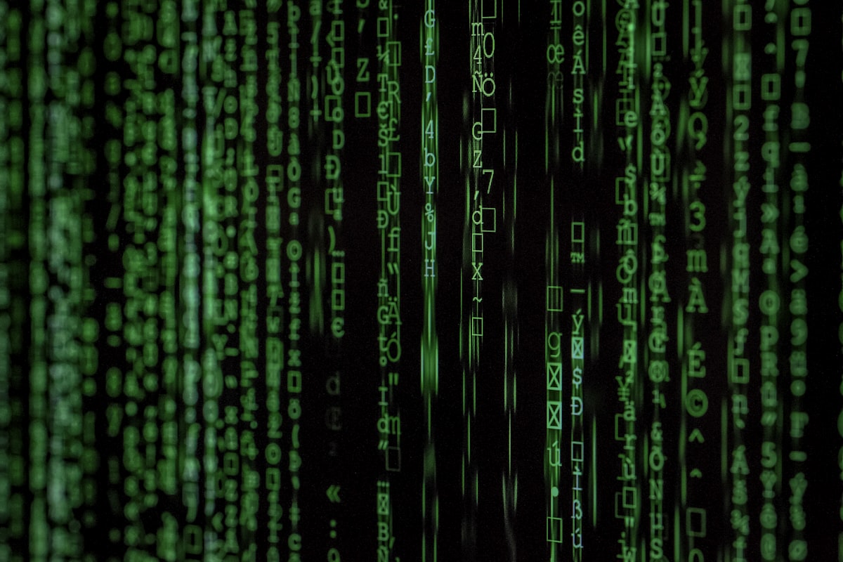 Green flowing code characters cascade down a dark background, evoking a matrix-style digital scene