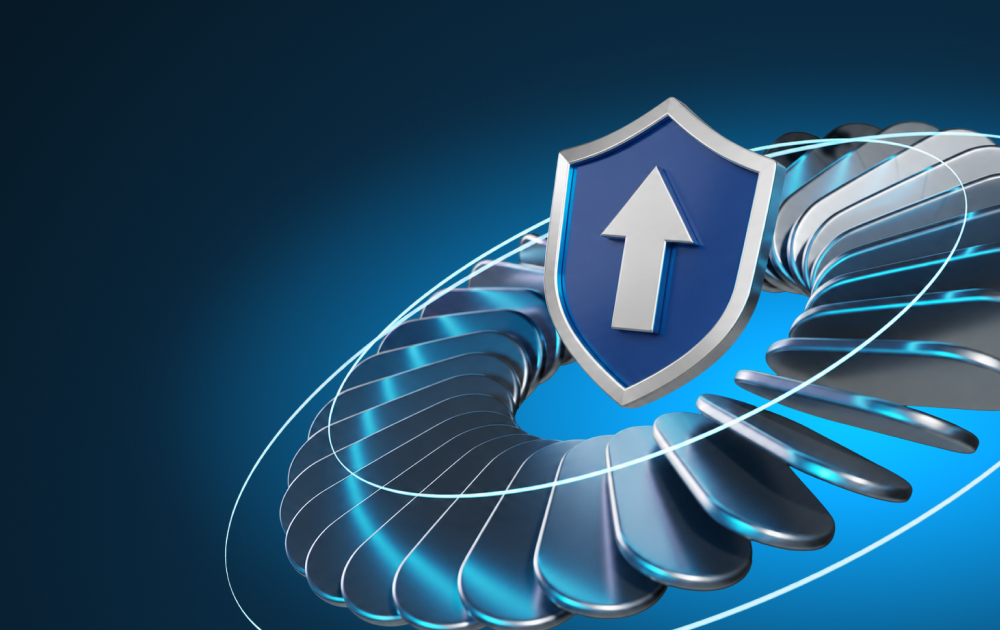 Blue shield with a white upward arrow over a metallic circular security motif, symbolizing protection and cybersecurity.
