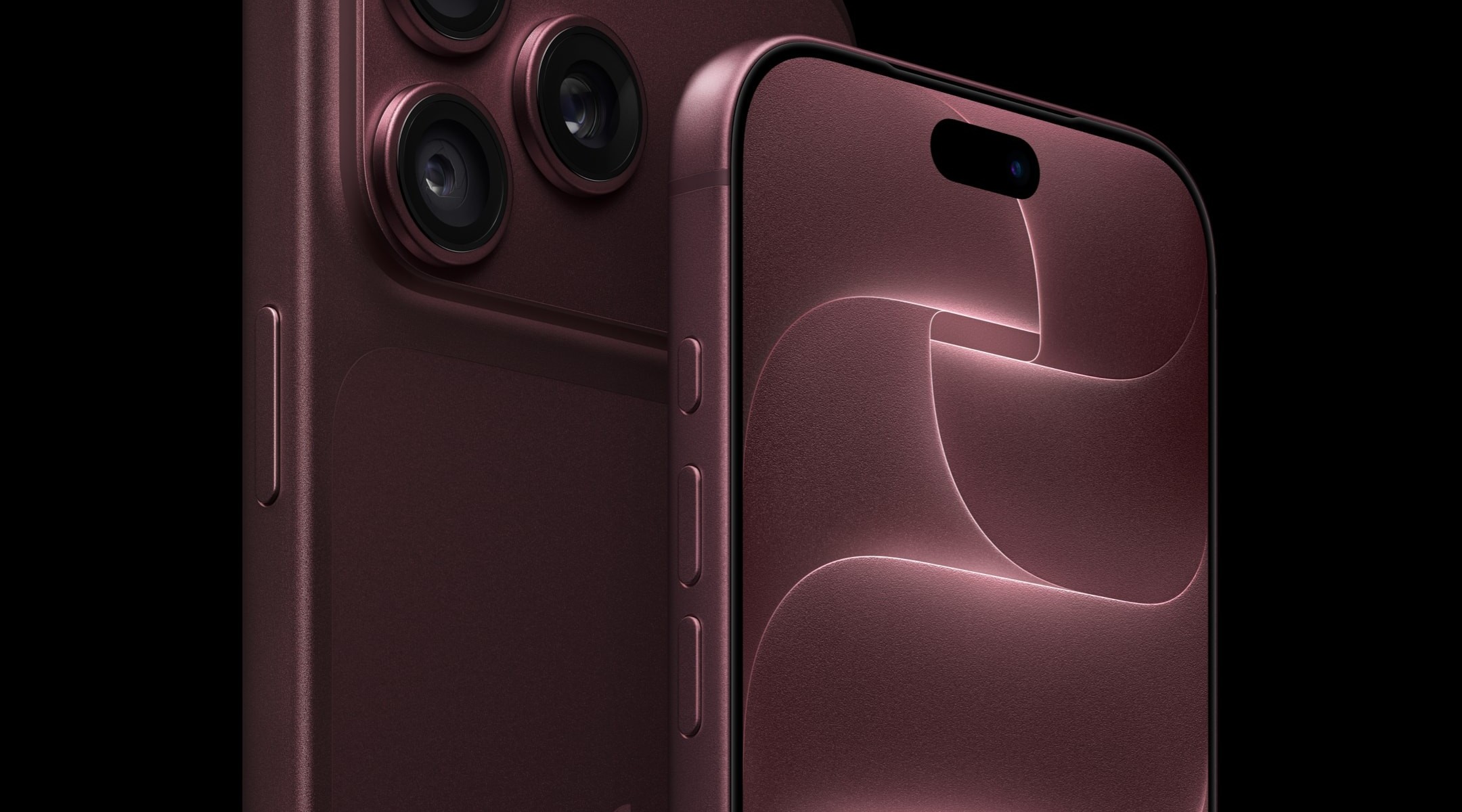 Close-up of a burgundy smartphone back showing a triple-camera array and textured finish with a side button visible on the left edge.