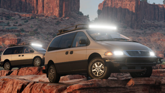 Two lifted minivans with light bars and bull bars crawling over red rock