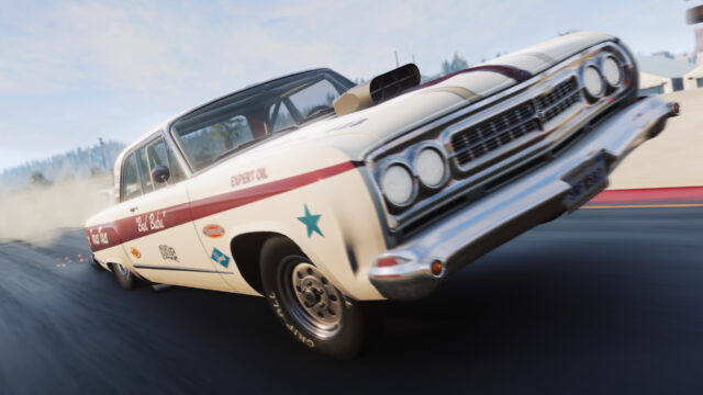 White drag sedan with a hood scoop lifting its front wheels off the line