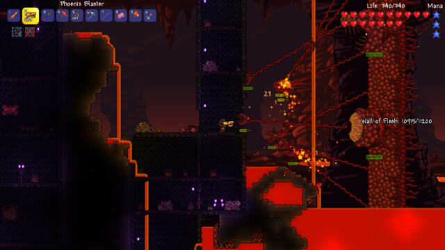 Fighting the Wall of Flesh above the underworld's lava with a Phoenix Blaster